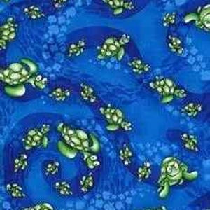 May include: Blue fabric with a repeating pattern of green sea turtles. The turtles have white and yellow accents and are swimming in a wavy pattern. The background is a deep blue color.