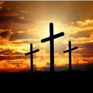 May include: Three wooden crosses silhouetted against a vibrant orange and red sunset sky.