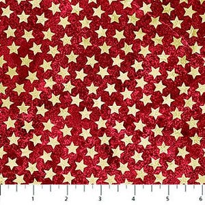 May include: Red fabric with a pattern of gold stars. The stars are evenly spaced across the surface. The fabric has a slightly textured appearance. A ruler is at the bottom of the image, showing measurements in inches.