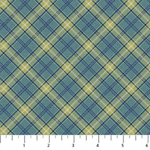 May include: A close-up of a fabric with a plaid pattern. The pattern features intersecting lines in shades of blue, green, and yellow, creating a grid-like design. The ruler at the bottom shows measurements in inches.