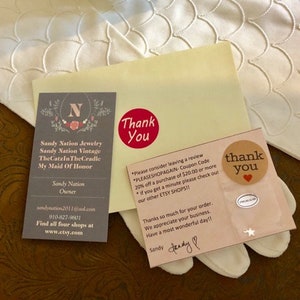 May include: Thank you card with a red heart and the text "Thank You" in a circle. The card also has the text "Please consider leaving a review. PLEASSHOPAGAIN - Coupon Code 20% off a purchase of $20.00 or more. If you get a minute please check out our other ETSY SHOPS!!" and "Thanks so much for your order. We appreciate your business. Have a most wonderful day!!" with a handwritten signature that says "Sandy".