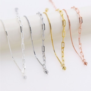 May include: Five silver, gold, and rose gold chain bracelets with different link styles. The bracelets are all the same length and have a lobster clasp closure.