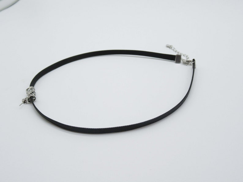 May include: A black choker necklace with a silver clasp and a silver chain detail.