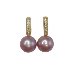 May include: A pair of gold hoop earrings with a single pink pearl dangling from each hoop. The hoops are accented with small clear stones.