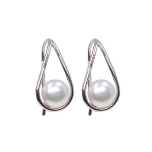 May include: A pair of silver earrings with a teardrop shape and a single pearl in each earring.