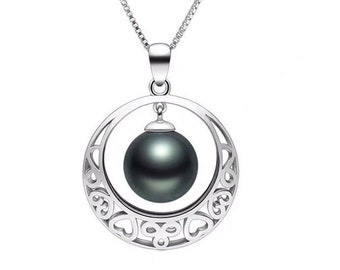 May include: A silver necklace with a black pearl pendant. The pendant is a circle with a delicate design and the pearl hangs from the center.
