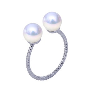 May include: A silver ring with two white pearls on a twisted band.