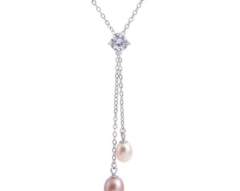 May include: A silver chain necklace with a single clear crystal pendant and two pink pearls hanging from the bottom.