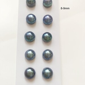May include: Eight round, iridescent blue pearls, each measuring 8-9 mm, are displayed on a white card. The pearls are arranged in four rows of two pearls each.