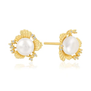 May include: A pair of gold earrings featuring a pearl and small diamonds set in a floral design.