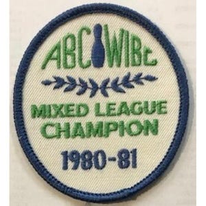 May include: Round patch with a blue border and a cream-colored center. The patch features green text that reads "ABC WIB", "MIXED LEAGUE CHAMPION", and "1980-81". A blue bowling pin graphic is at the top.