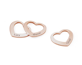 May include: Three rose gold heart-shaped charms with the names Lucy, Mason, and Oliver engraved on them.