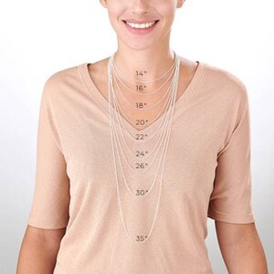 May include: A model wearing a variety of silver chain necklaces, each labeled with its length in inches, from 14 inches to 35 inches.