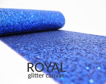 May include: A roll of royal blue glitter canvas fabric. The fabric is sparkly and has a textured surface.