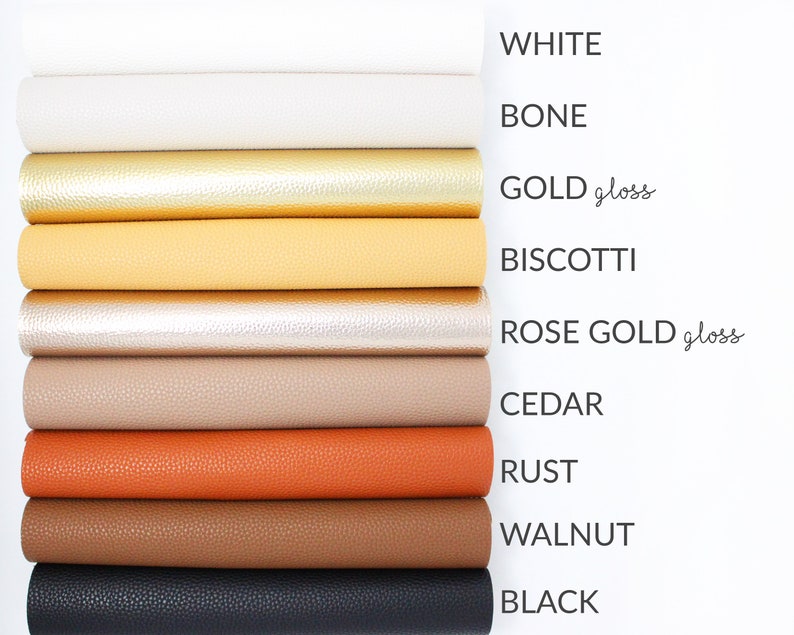 May include: A stack of ten different coloured faux leather sheets. The colours are white, bone, gold gloss, biscotti, rose gold gloss, cedar, rust, walnut, and black.