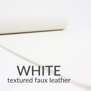 May include: White textured faux leather. This material is great for crafting projects.