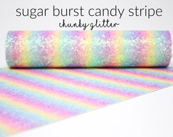 May include: A roll of sugar burst candy stripe chunky glitter fabric. The fabric features a rainbow of pastel colors, including pink, yellow, blue, and purple, with a glittery texture. The text "sugar burst candy stripe chunky glitter" is printed on the top.