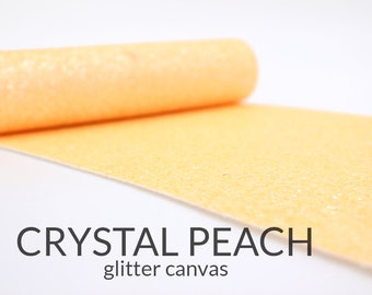 May include: A roll of peach-colored glitter canvas fabric. The fabric is textured with a fine glitter finish. The text "CRYSTAL PEACH glitter canvas" is printed below the fabric.