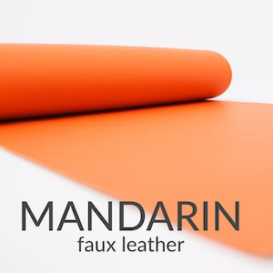 May include: A roll of bright orange faux leather fabric. The fabric is unrolled and the text "MANDARIN faux leather" is visible.