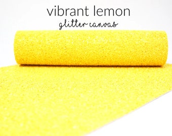 May include: A roll of vibrant lemon glitter canvas fabric. The fabric is yellow with a sparkly texture.