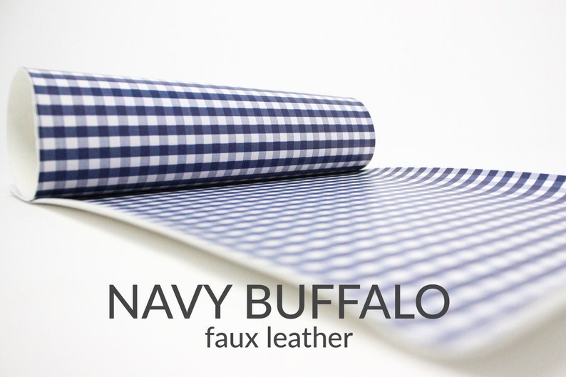 May include: A roll of navy blue and white gingham faux leather fabric. The fabric has a checkered pattern.