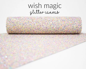 May include: A roll of iridescent glitter canvas with the text "wish magic glitter canvas" printed on a white background.