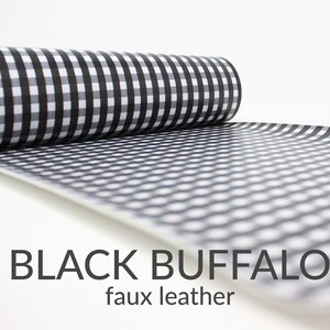 May include: A roll of black and white buffalo check faux leather fabric.