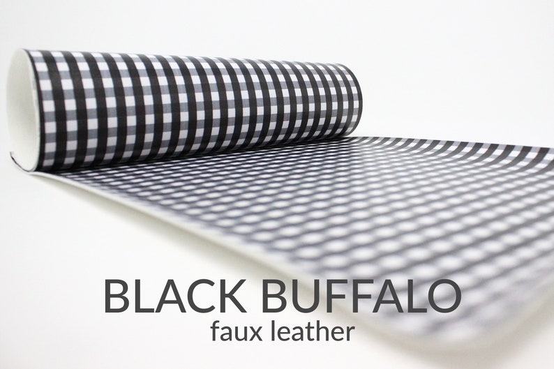 May include: A roll of black and white buffalo check faux leather fabric.