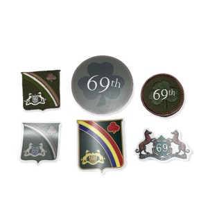 May include: Six different green, brown, and white stickers with the number 69 and the words "69th" on them. The stickers are in the shape of a clover, a shield, and a crest.