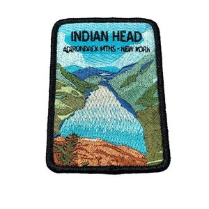 May include: Embroidered patch with a scenic view of a lake and mountains. The patch is black with white stitching and reads "INDIAN HEAD ADIRONDACK MTNS - NEW YORK".
