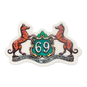 May include: A white sticker with a green and gold crest featuring the number 69. Two brown dogs with red collars are flanking the crest. The text "Gentle When Stroked Fierce When Provoked" is written on a banner below the crest.