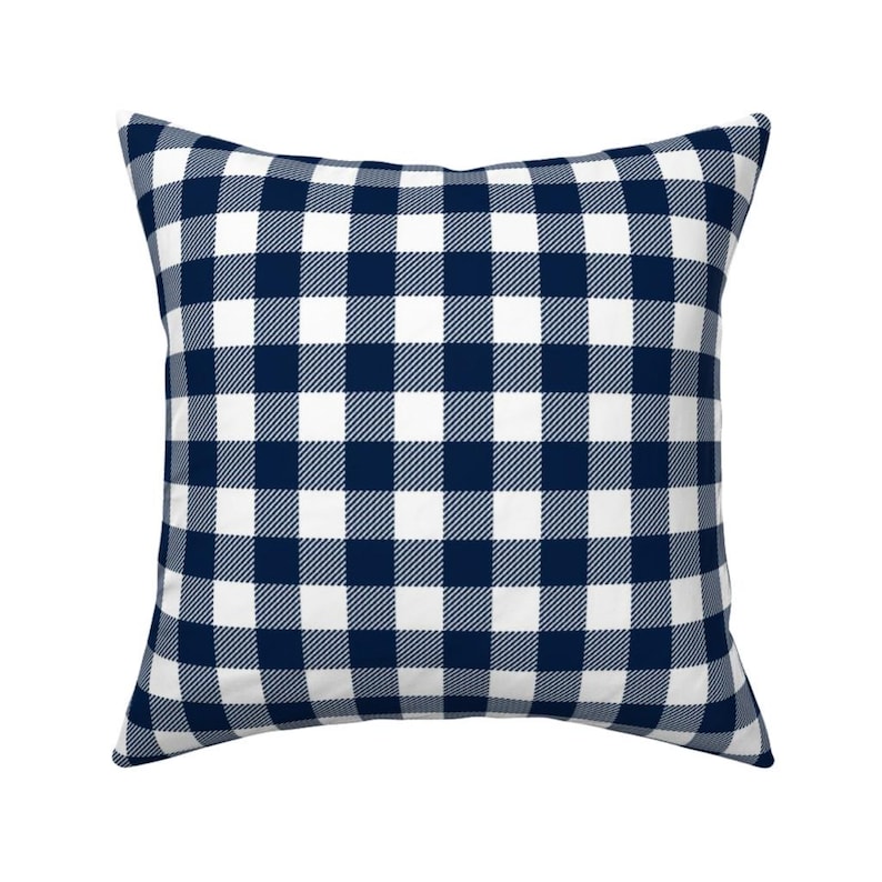 May include: A square pillow with a navy blue and white gingham pattern.