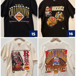 May include: Four vintage Houston Rockets t-shirts. The first two are black with the team logo and the words "NBA World Champions" and "Back 2 Back World Champions". The third is cream with a basketball player and the words "Houston Rockets 94 NBA Finals Champions". The fourth is white with the words "Western Conference Champions The 1994 NBA Finals Rockets".