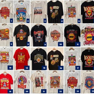 May include: A collection of 24 vintage Houston Rockets t-shirts featuring various designs and logos from the 1994 NBA season. The shirts are in different colors, including white, black, red, and blue. Some of the shirts feature the team's logo, while others feature the words "Houston Rockets" or "Champions".