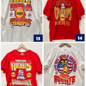 May include: Four vintage Houston Rockets t-shirts. The first two shirts are red and white, with the text "WORLD CHAMPS" and "1994 NBA Finals". The third shirt is red with the text "HOUSTON ROCKETS" and "1994 NBA Finals". The fourth shirt is white with the text "1994 NBA World Champions" and "HOUSTON ROCKETS".