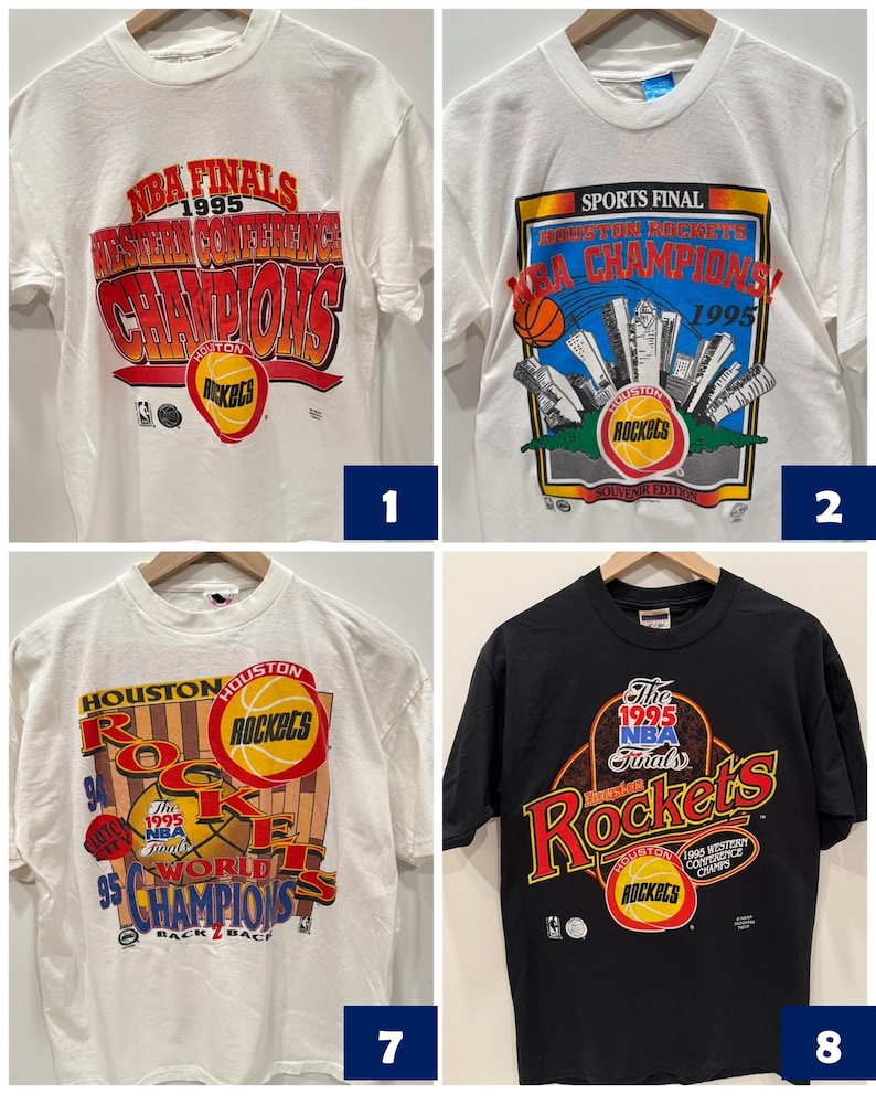 May include: Four vintage Houston Rockets t-shirts. The first two are white with red, blue, and yellow graphics. The third is white with red, blue, yellow, and black graphics. The fourth is black with red, blue, yellow, and white graphics.