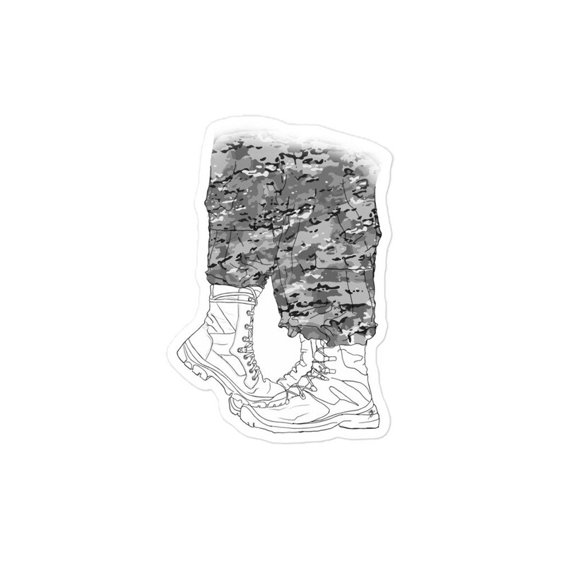 May include: A pair of black and white camouflage pants with black boots. The boots have laces and are tied at the top.