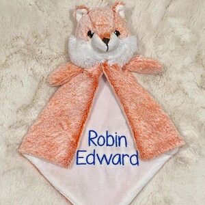May include: A soft, orange and white plush fox security blanket with the name "Robin Edward" embroidered in blue thread.