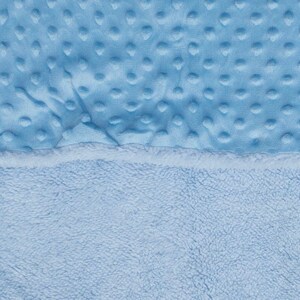 May include: A soft blue baby blanket with a textured side and a fluffy side.