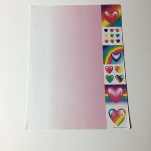May include: A sheet of stationery with a pink gradient background and a decorative border. The border features colorful hearts and rainbows. The hearts are in various colors, including red, yellow, blue, and pink.