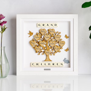 May include: A white framed picture with a wooden tree with hearts and names on it. The tree is surrounded by butterflies, birds, and a rabbit. The words "GRAND" and "CHILDREN" are spelled out with letter tiles.