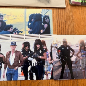 May include: A set of four black and white photographs showing a group of people on a film set. The photos show a group of people in a scene with a police officer, a group of people in a scene with a police officer and a woman in a dress, a group of people in a scene with a police officer and a woman in a dress, and a group of people in a scene with a police officer and a woman in a dress.