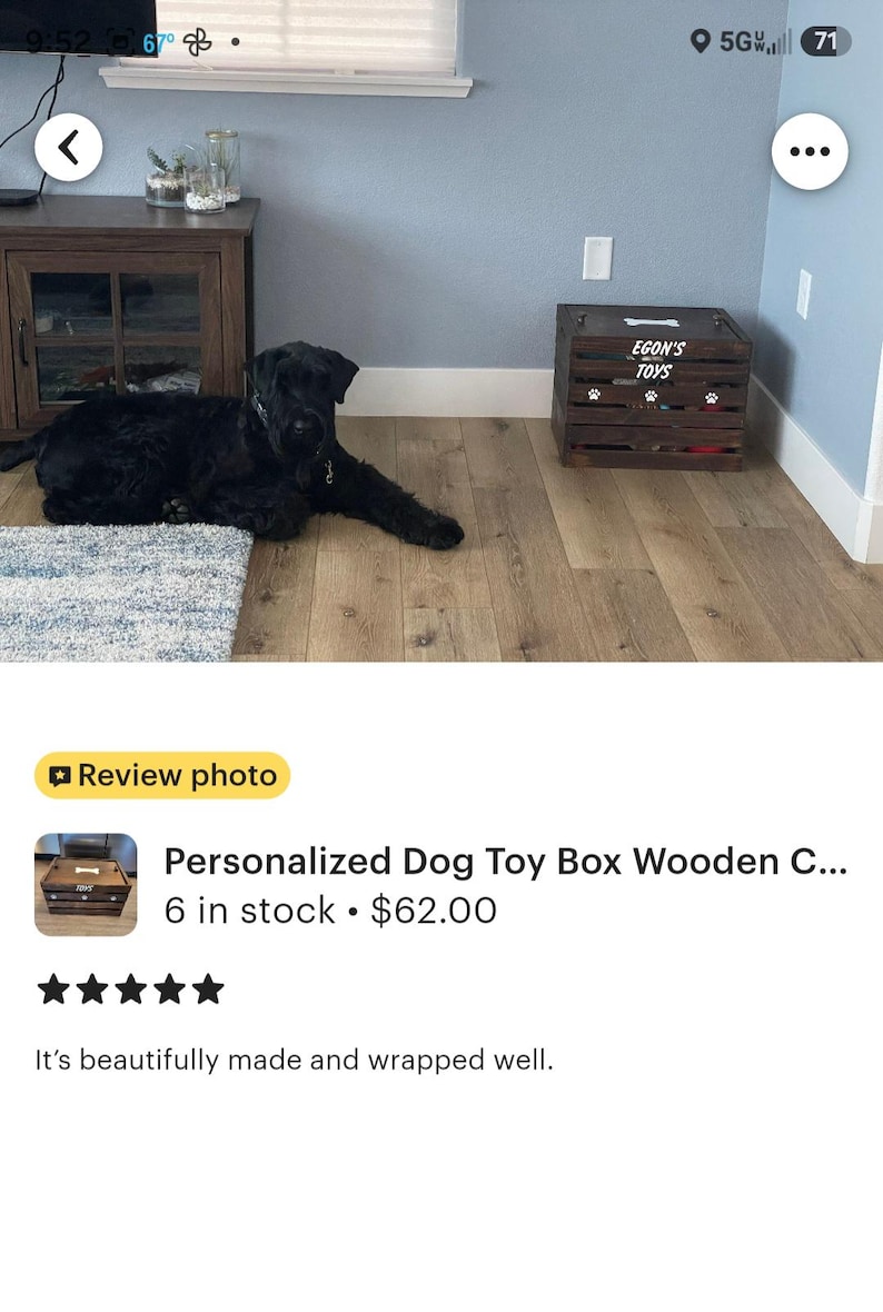 May include: A dark brown wooden crate with horizontal slats, featuring the white text "EGON'S TOYS" on the front panel, accompanied by a white bone graphic above the text and three white paw print graphics positioned below the text.