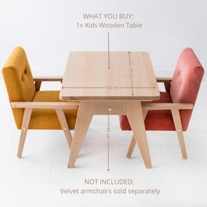 May include: A light-colored wooden kids table with a rectangular top measuring 50 cm by 70 cm and a height of 46 cm. The table is flanked by two upholstered armchairs, one mustard yellow and one coral pink, which are not included in the purchase.