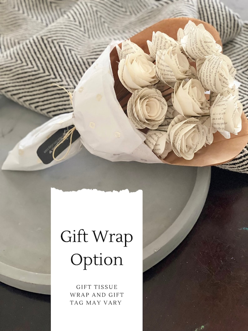 May include: A bouquet of white paper roses wrapped in brown paper and white tissue paper with gold polka dots. The bouquet is tied with twine and a small tag that says "Gift Wrap Option". The text "GIFT TISSUE WRAP AND GIFT TAG MAY VARY" is also included.
