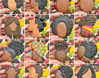 May include: A collection of 10 different decorated sugar cookies, each featuring a unique design of a person with a different hairstyle. The cookies are all brown and have a variety of hair colors, including black, brown, blonde, and red.