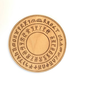 May include: A wooden circular disc with a ring of Ethiopian alphabet characters around the edge.