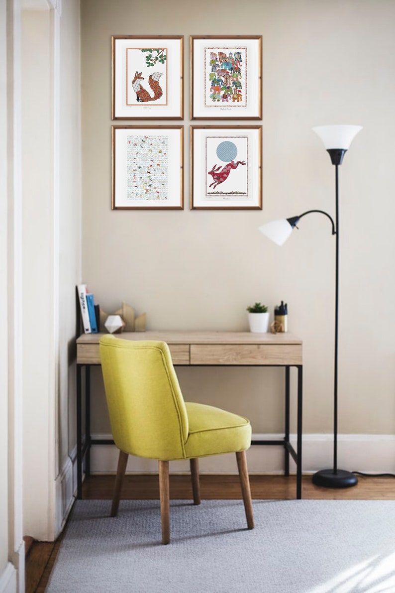 Various prints displayed on wall above a desk.