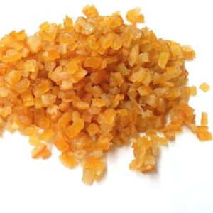 May include: A pile of orange candied citrus peel, also known as orange zest, on a white background.
