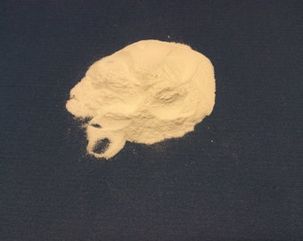 May include: A pile of white powder on a blue surface.